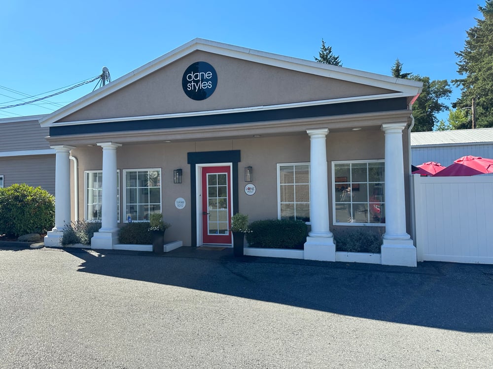 Exterior of DaneStyles Hair Artistry, an organic hair salon in Snohomish, WA, with white columns and a red front door