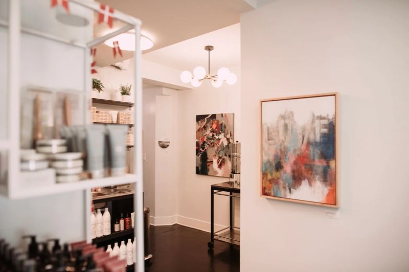 DaneStyles Hair Artistry salon interior with Danish flags, modern lighting, and art