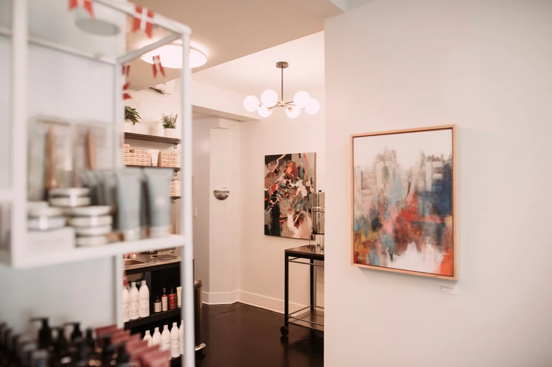 Interior of DaneStyles Hair Artistry in Snohomish, WA with Danish flag bunting, product shelves, and local artwork